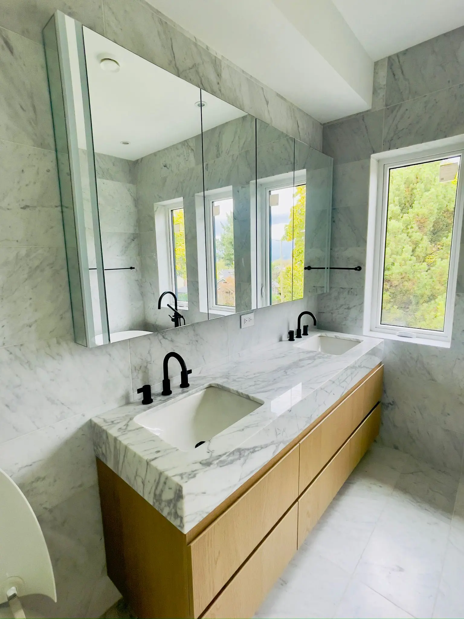 A finished double vanity in marble with wood cabinetry, plumbed by JB26 Plumbing & Heating Ltd.