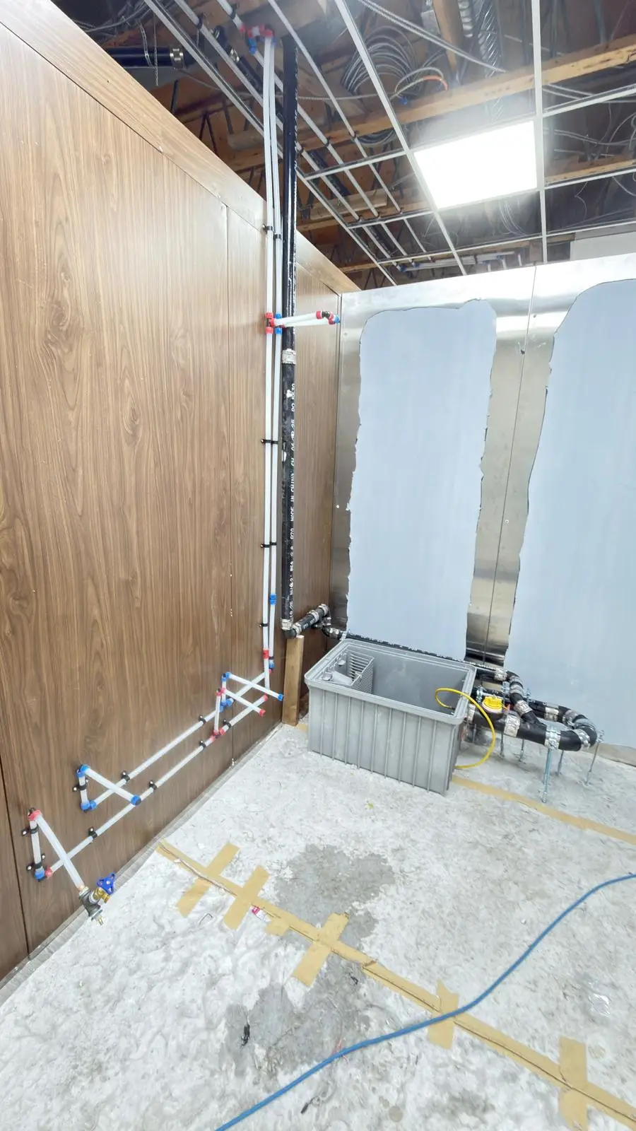 A grease interceptor and the supply riser feeding a new kitchen.