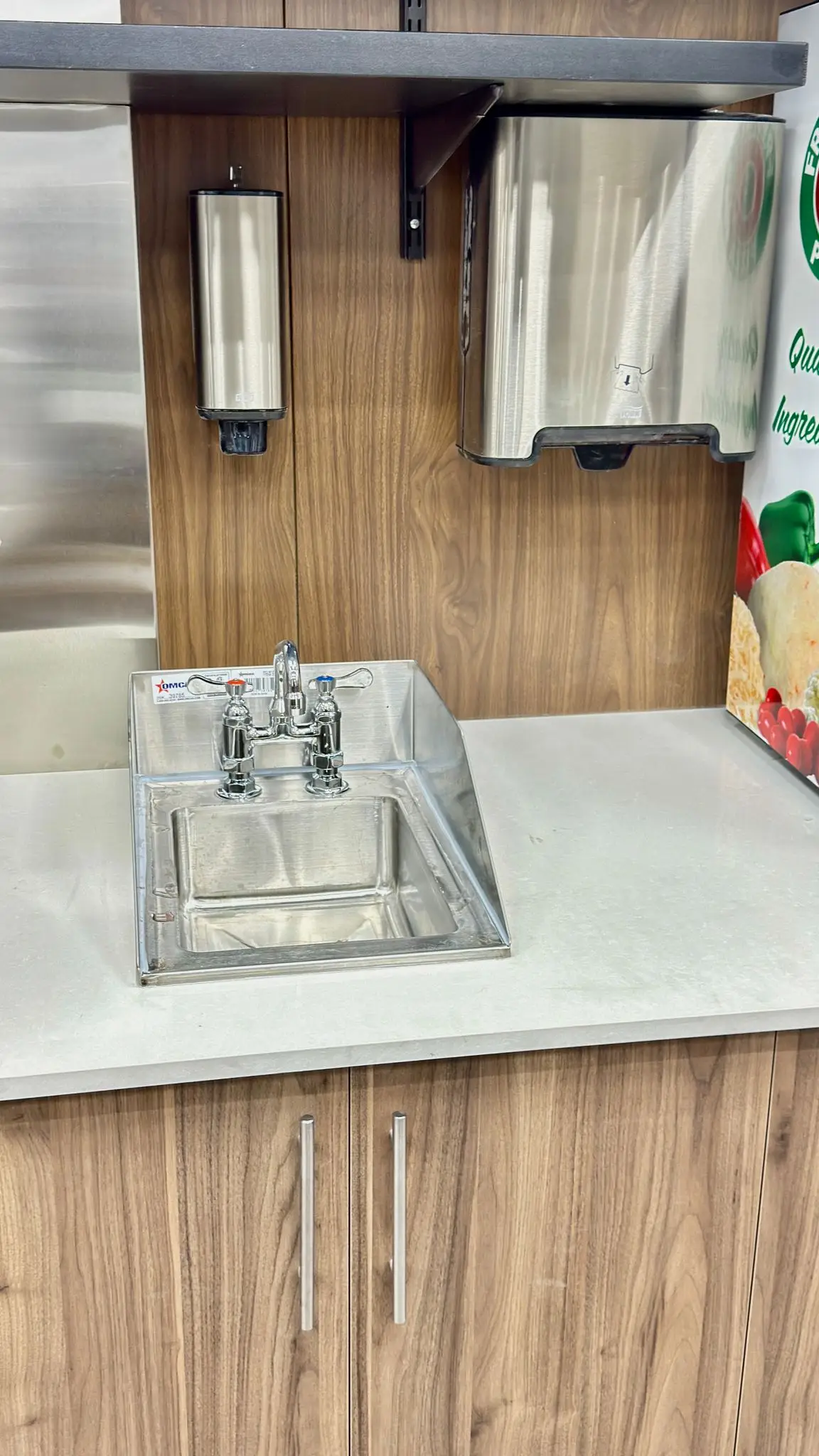 A drop-in prep sink and mixer set into a service counter.