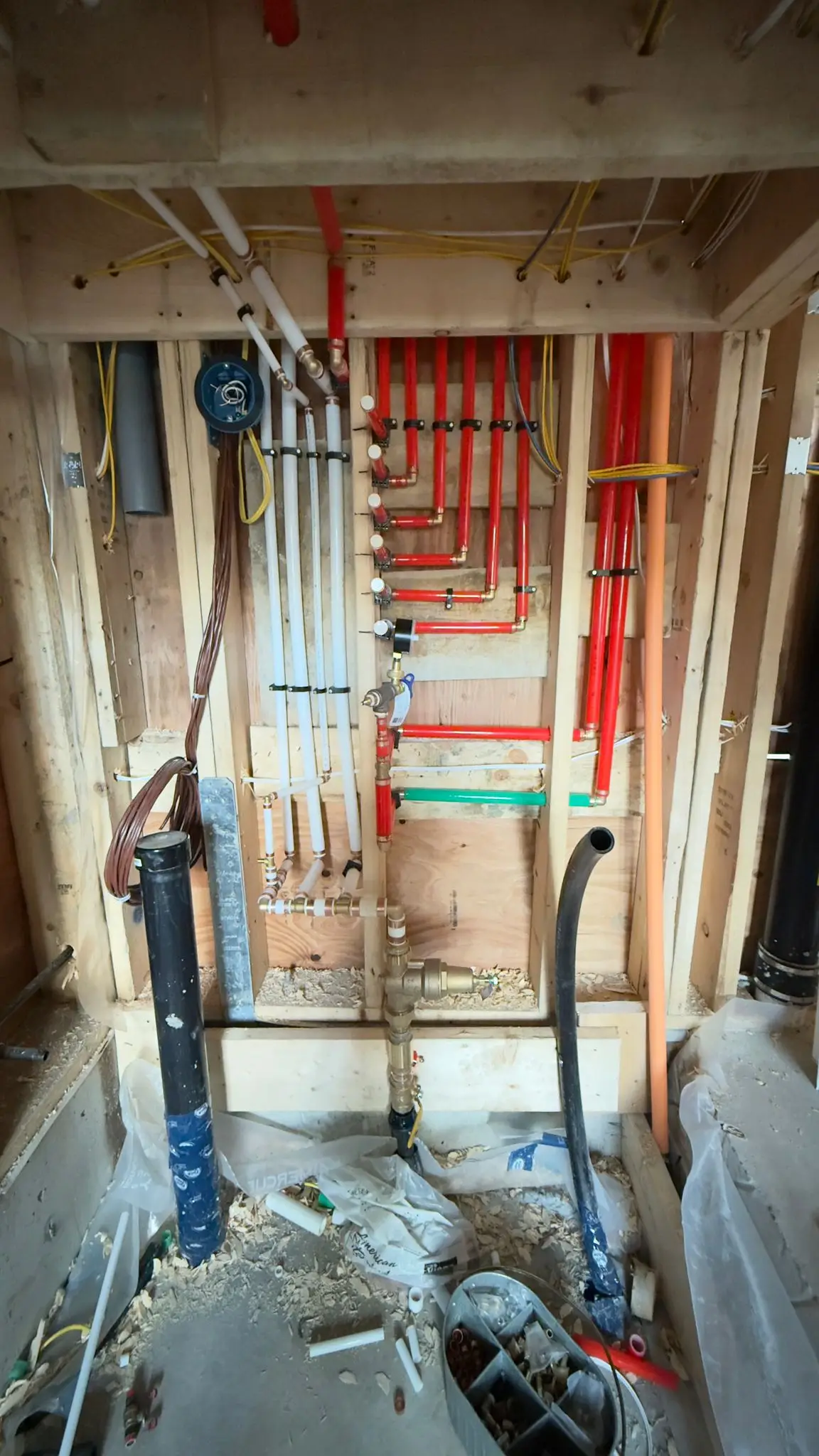 Supply lines held under test pressure against the stack before the walls close.