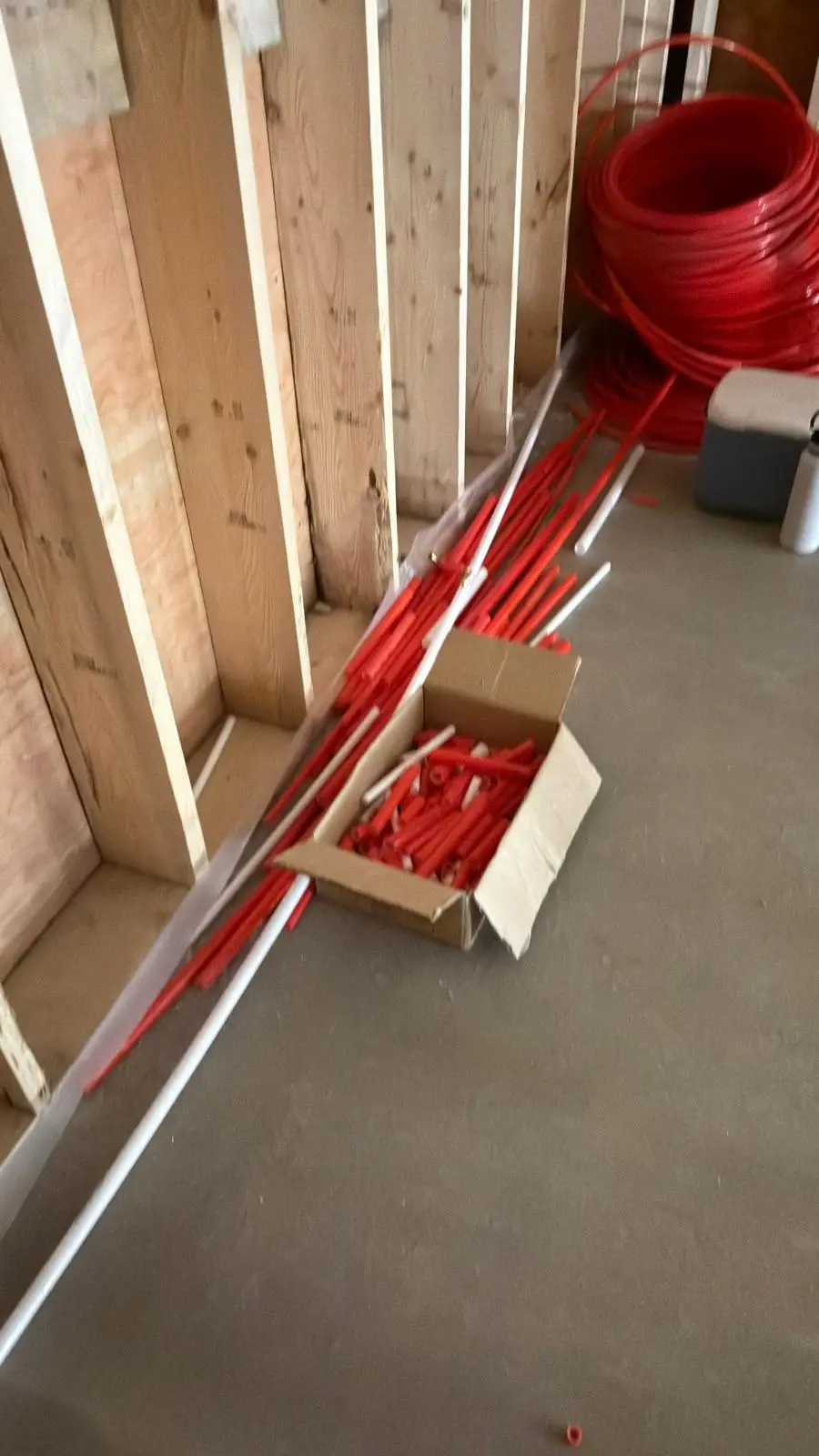 Red PEX lines brought out of the wall to a new expansion tank.