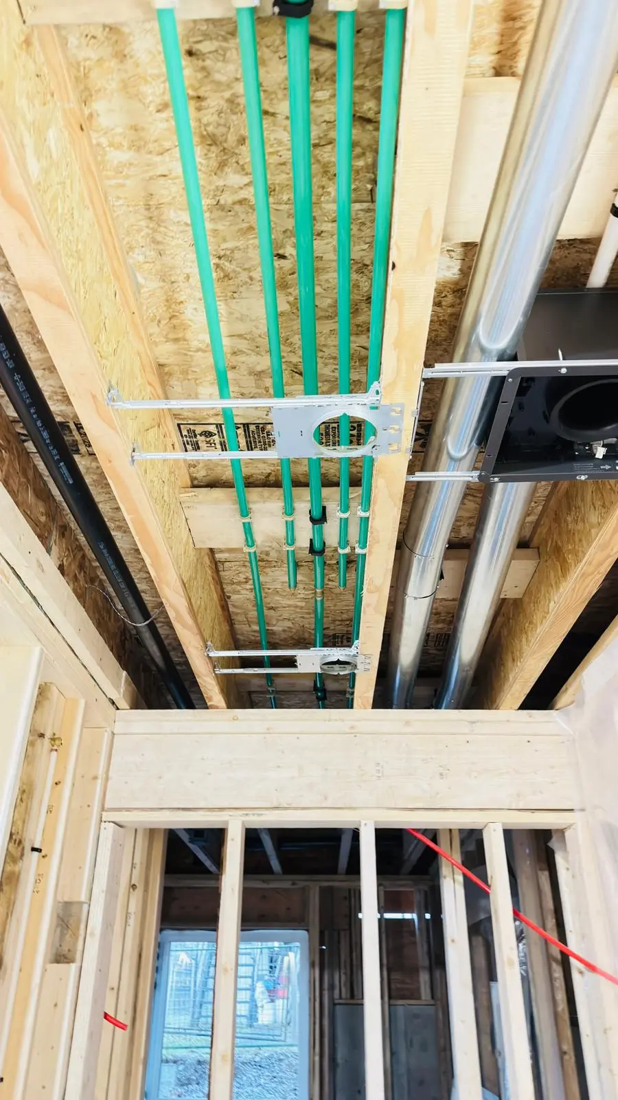 Radiant tubing carried through the joists on steel protection plates.