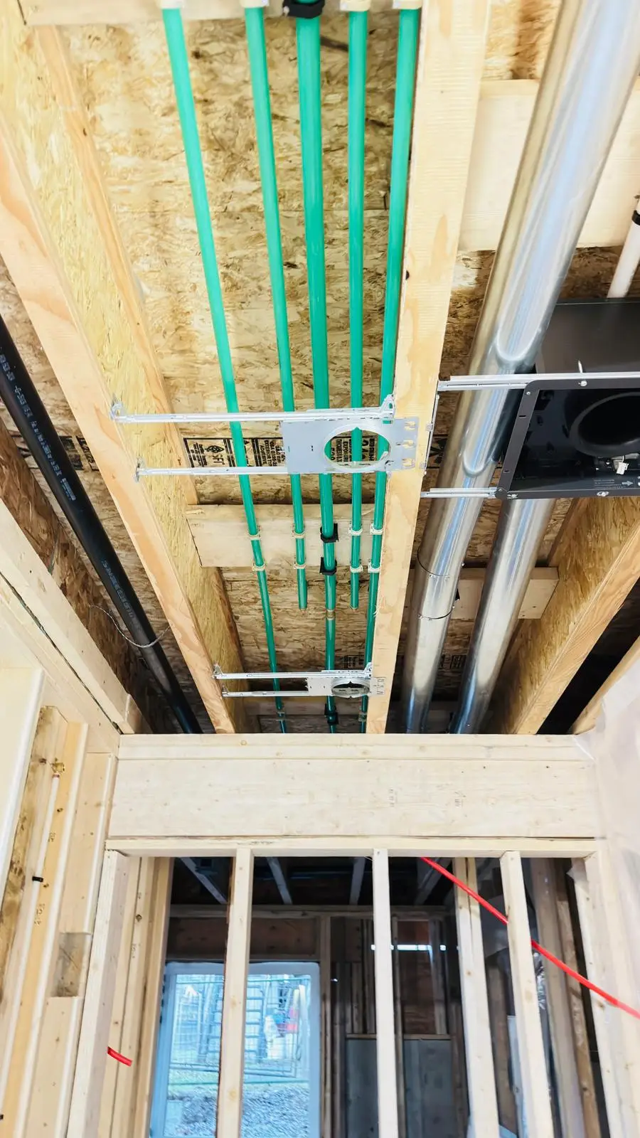 Radiant tubing carried through the joists on steel protection plates.