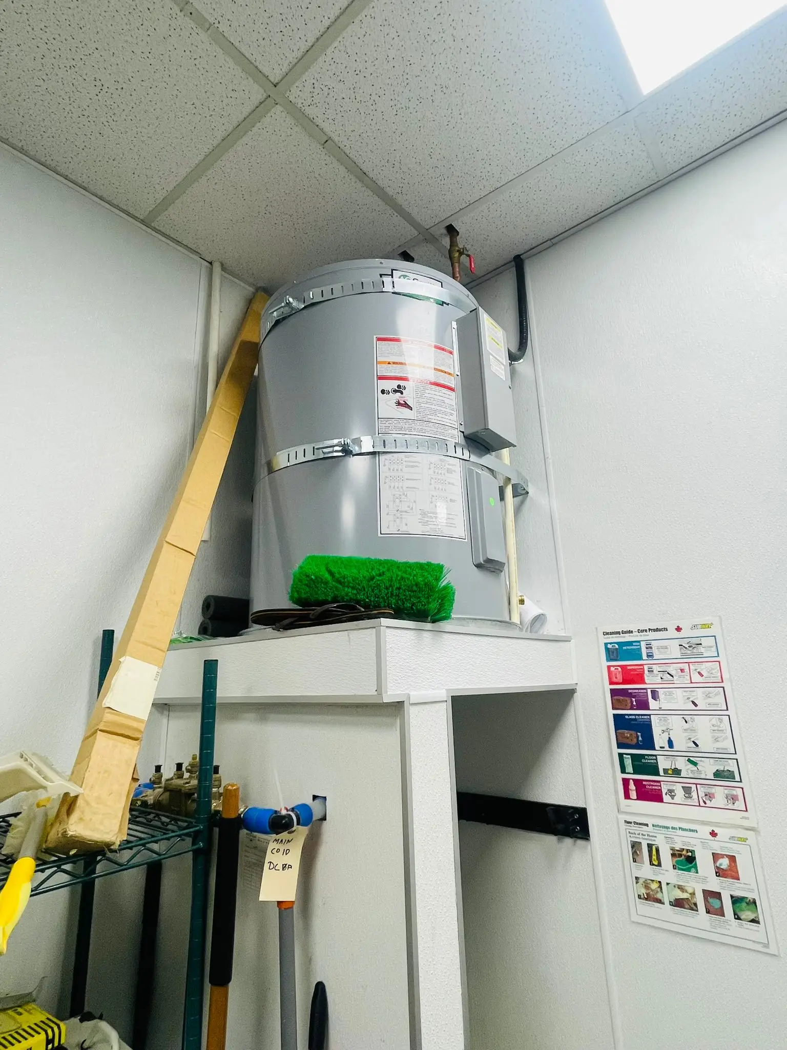 A water heater installed in the back of house of a restaurant fit-out.