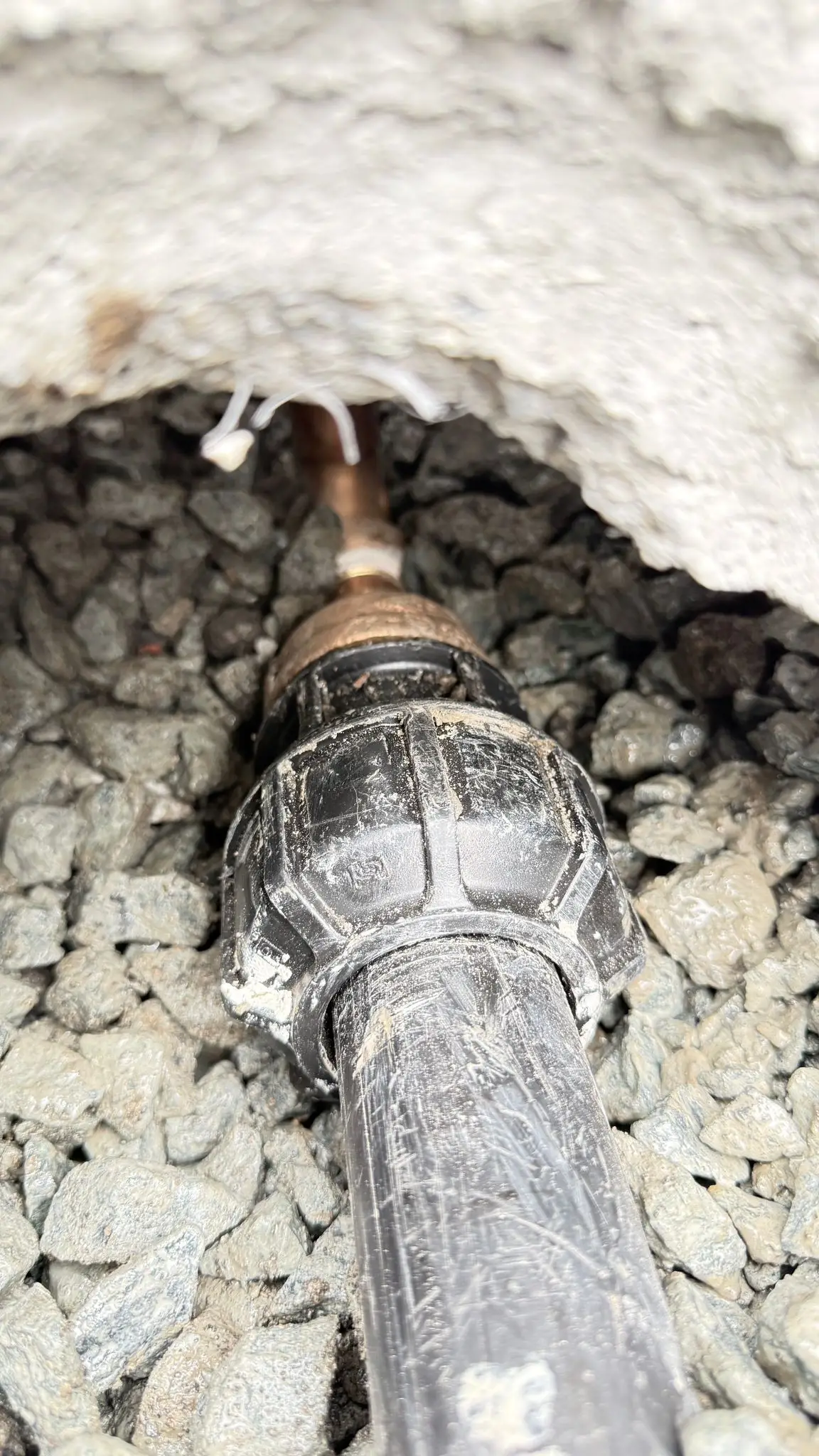 A new poly water service made up to its fitting in the gravel bed.