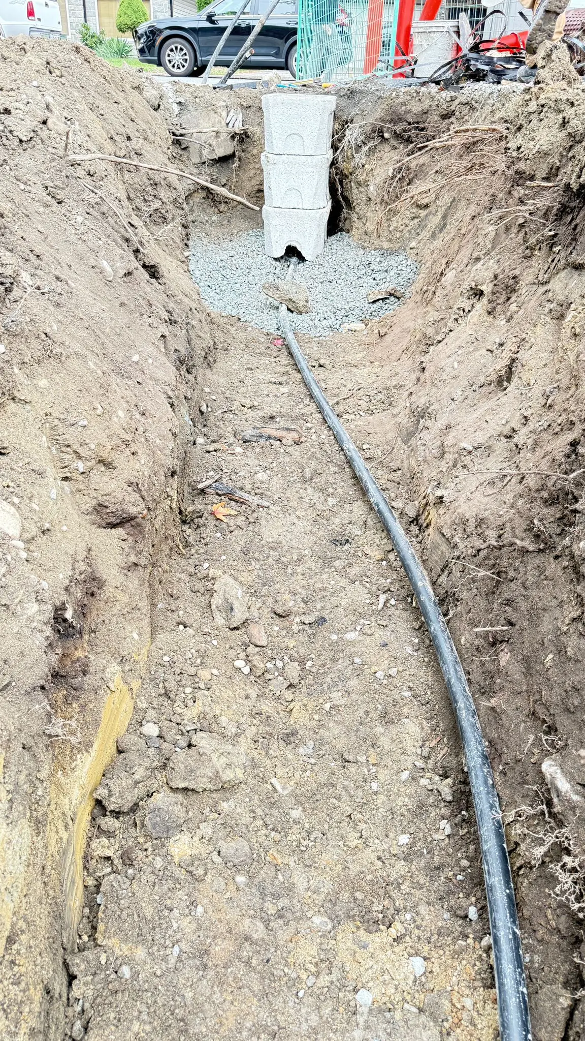 A new water service laid on its bedding in the open trench.